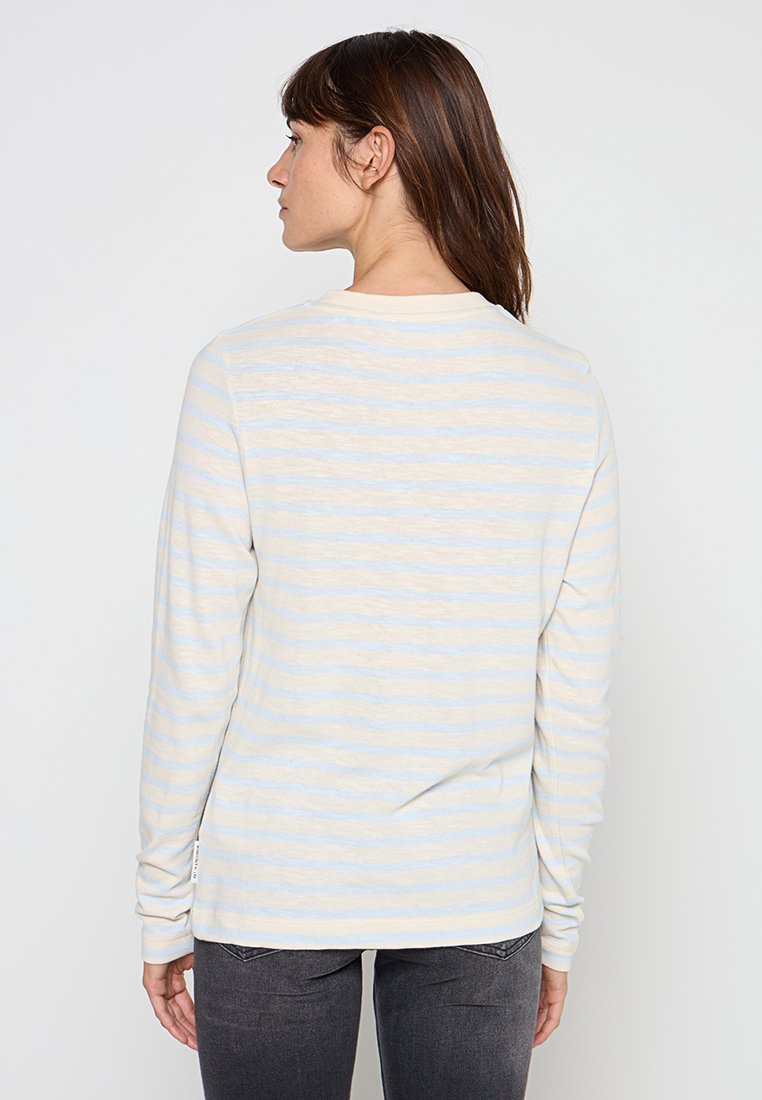 Koszula z długim rękawem w kolorze kremowym z jasnoniebieskimi pionowymi paskami. Miękka tkanina i okrągły dekolt z prostym wykończeniem. Prosty, casualowy design.