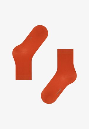 Chaussettes de cheville orange en tissu lisse, avec une couleur unie, un bord côtelé et un logo en bas. Conçues pour le confort.