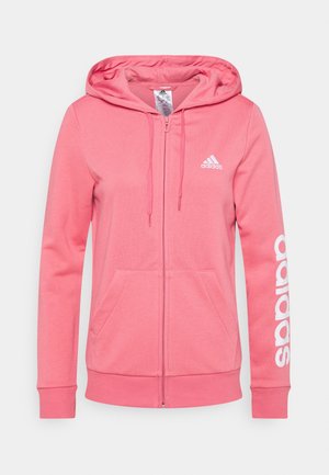 Sweat à capuche Adidas rose à glissière complète avec poches avant, capuche à cordon, logo Adidas blanc sur la poitrine et grand texte Adidas sur la manche gauche.