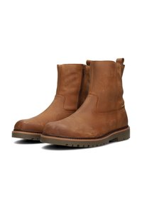 Botas de tobillo de cuero marrón con una textura suave, cremallera lateral y suela de goma. Presentan una punta redonda y detalles de costura mínimos.