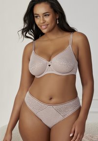 Light beige lace lingerie set with a dotted texture. Bra features underwire, adjustable straps; matching high-waisted briefs with similar pattern.