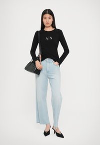 Musthave must-haves must-have must-have must-have must-have.A number of things you might actually be concerned about . That's where the black long-sleeve shirt with white graphic, light blue wide-leg jeans, black handbag with striped strap, and black pointed heels come in.