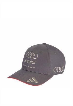 Gorra de béisbol gris con el logo de los aros de Audi, texto "Revolut F1 Team" en el frente y logo de Adidas en el borde de la visera con ribete rojo debajo.