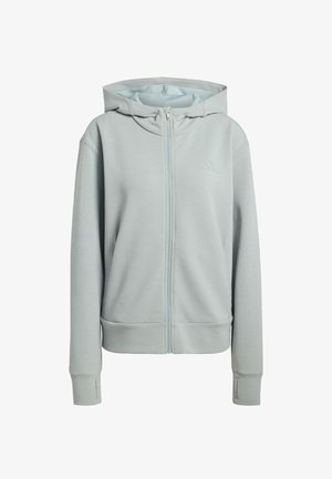 Vaalea harmaa vetoketjullinen huppari, jossa on sileä pinta, kengurupockets, ribbireunukset ja pieni logo vasemmassa rintakohdassa.