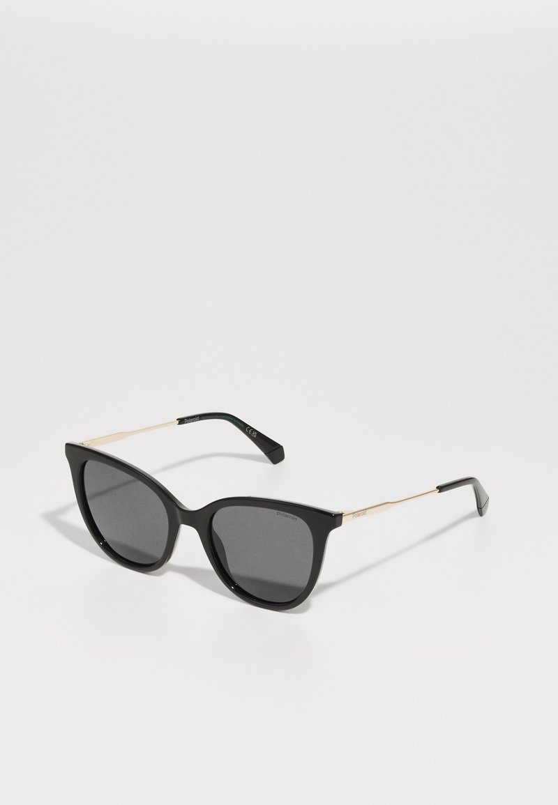 Black cat-eye sunglasses with dark lenses. Features thin gold metal accents on the temples and a smooth, glossy frame finish.
