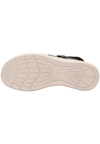 Černá bota s texturovaným svrchním materiálem a bílou gumovou podrážkou. Obsahuje protiskluzový vzor a branding na podrážce.