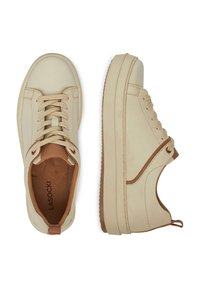 Beezid ketsid siled nahkine pealmise ja tonalist lukkudega, pruunide aktsentidega. Paksema tallaga, millel on tekstuurne muster. Brändi logo on nähtav seestpoolt.