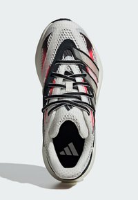 Shoe with a mesh upper, predominantly white with black and red accents, featuring black laces and an Adidas logo on the tongue.