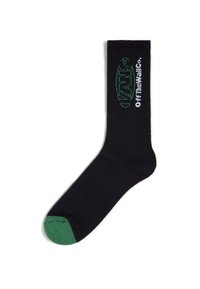 Schwarze Crew-Socke mit geripptem Textur, mit grünem Zehenbereich und gesticktem "VANS Off the Wall"-Logo in Grün und Weiß im oberen Bereich.