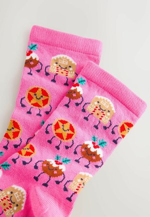 Pink socks featuring a repeated pattern of cartoon cookies and festive treats, with colorful accents and a soft, textured fabric.
