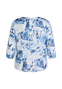 White blouse featuring a blue floral and scenic photo print, with three-quarter sleeves and a gathered neck detail. Smooth texture.