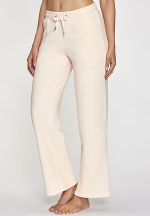 Hellrosa Jogginghosen mit Kordelzugbund, zwei Seitentaschen, weiter Beinführung und weichem, strukturiertem Stoff.