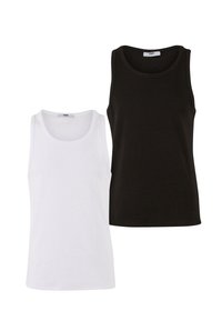 Two tank tops, one white and one black, made of soft cotton. They have rounded necklines and no visible patterns or accents.