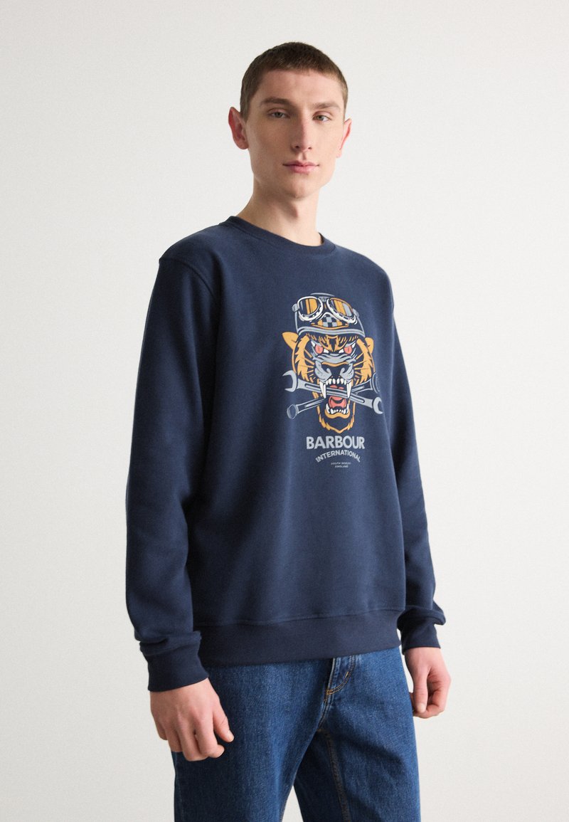 Navy blue sweatshirt made of cotton, featuring a graphic of a tiger with goggles and tools, and "Barbour International" text.