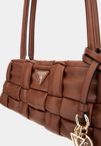 Borsa a tracolla in eco-pelle intrecciata marrone, con una placca a forma triangolare e due manici sottili, con dettagli in hardware dorato.