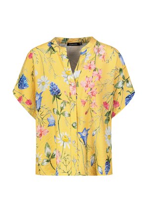 Gelbe Bluse mit kurzen Ärmeln, die ein florales Muster mit blauen, rosa und weißen Blumen aufweist. Mit Knopfleiste und einem geknöpften Kragen-Design.