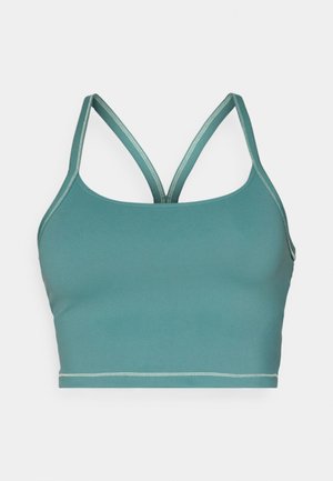 Teal spordirinnahoidja ruudukujulise kaelusega ja kahekordsete rihmadega. Omab siledat, venivat materjali ja kontrastset ääristust servadel.