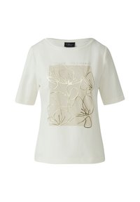 T-shirt en coton crème à manches courtes, avec un motif floral imprimé en or et le texte "SUIVEZ VOS RÊVES" dans un cadre rectangulaire.