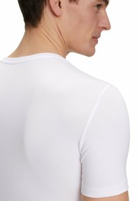 White short-sleeve T-shirt made of smooth cotton, featuring a crew neckline and fitted design, showing the back view and neckline details.