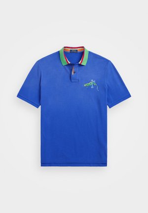 Blue polo shirt with green collar, red and white stripe accents, and embroidered lizard design on the left chest. Short sleeves.