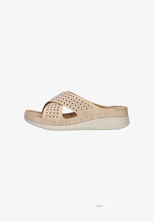 Las sandalias de slide color beige presentan una parte superior perforada con elementos decorativos, una suela acolchada para mayor comodidad y un diseño casual adecuado para climas cálidos.