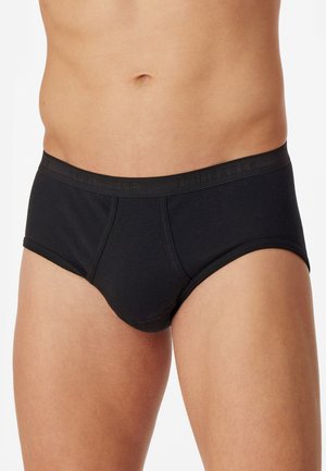 Svart bomullsboxer med slät yta, med en enhetlig färg och elastiskt midjeband. Designen har en åtsittande form och minimal detaljering.