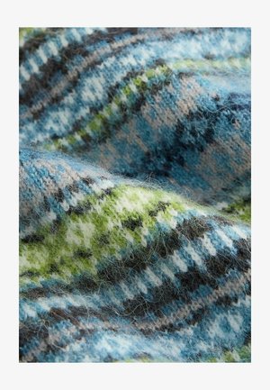 Soft, fuzzy wool fabric with blue, green, white, and black plaid pattern draped with visible texture and fibers.