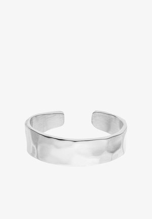 Wide, open-ended silver cuff bracelet with a slightly hammered, polished surface and smooth rounded edges.