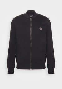 Sweat-shirt noir zippé avec col montant, manches longues et petit motif brodé sur la poitrine. Tissu lisse et poignets côtelés.