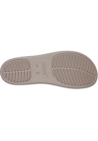 Semelle de chaussure en caoutchouc marron clair avec un motif de relief, comportant des rainures pour l'adhérence. Comprend un logo et les détails de taille embossés dans la zone centrale.