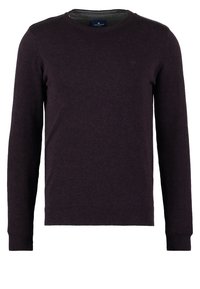 Pull à col rond de couleur violet foncé en tissu doux, avec des manches longues et des poignets et ourlet côtelés. Étiquette visible au niveau du col.