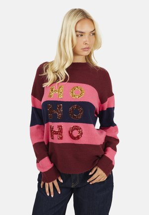 Maglione a righe rosse e rosa con scollo a girocollo, con lettere "HO HO HO" di paillettes in oro, rosso e marrone sul davanti.