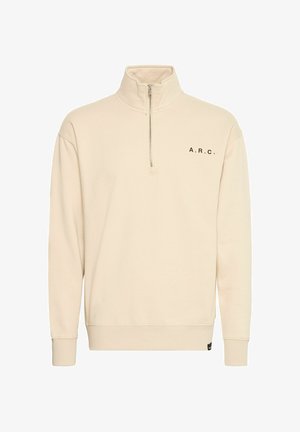 Beige zip-up sweatshirt with a high collar, black "A.R.C." lettering on the left chest, ribbed cuffs, and a relaxed fit. Soft fabric texture.