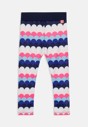 Des leggings avec une taille élastique bleu marine, présentant un motif en vagues colorées dans des teintes de rose, bleu et blanc sur un fond sombre.