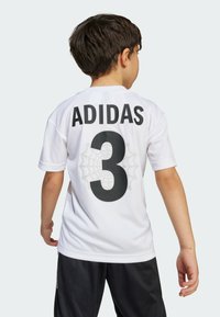 White Adidas jersey featuring a large black "3" on the back, with a spiderweb pattern behind the number. Short sleeves and a crew neckline.
