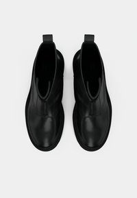 Pair of black leather ankle boots with front zippers and pull tabs, shown from above on a white background.