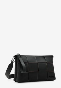 Black fabric clutch bag with a rectangular shape, featuring contrasting stitching in red and orange, and a detachable strap.