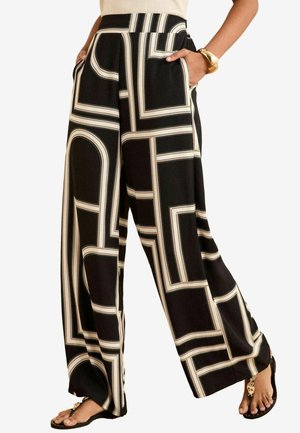 Wide-leg trousers in black with cream geometric pattern. Features pockets and a high waistband. Smooth fabric texture and relaxed fit.