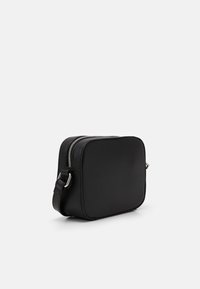 Black textured rectangular crossbody bag with silver zipper and adjustable strap on a white background.