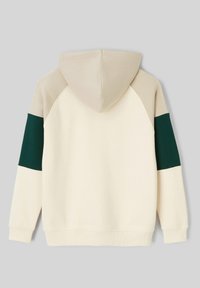 Sweat à capuche crème, avec des manches raglan beige et vert foncé. Tissu doux, poche kangourou, poignets et ourlet côtelés.