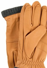 Brune læderhandsker med tre fingre og en grå strikket manchet, der har en struktureret overflade og syede detaljer.