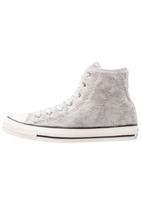 Wysokie sneakersy z białą gumową podeszwą i sznurówkami, pokryte miękkim, szarym, puszystym materiałem, przedstawione z zewnętrznej strony na białym tle.