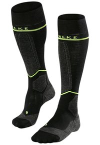 Knästrumpor i svart med limgröna detaljer, med en texturerad design, förstärkt häl och stöd för fotvalvet. Tillverkade av ett andningsbart material.
