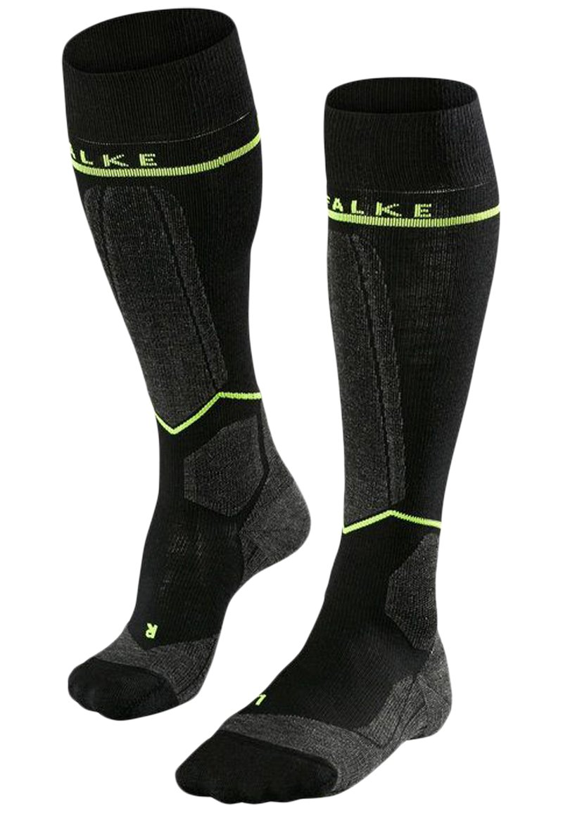 Knästrumpor i svart med limgröna detaljer, med en texturerad design, förstärkt häl och stöd för fotvalvet. Tillverkade av ett andningsbart material.