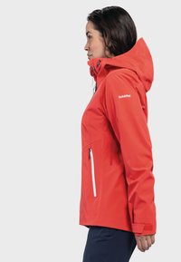 Red waterproof jacket with a hood, white zipper accents, and adjustable cuffs. Features a logo on the left sleeve and side zip pockets.