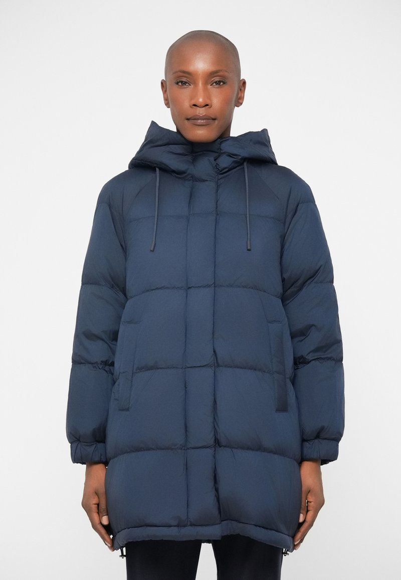 Navy blue puffer jacket with a hood, featuring quilted design, side pockets, and adjustable toggle strings for a snug fit.