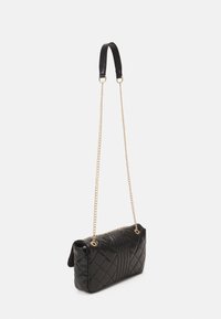 Quilted black leather handbag with a chain strap and a leather top handle; features a zip closure and sleek rectangular shape.