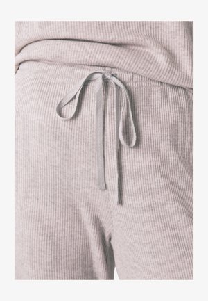 Pantalons de survêtement côtelés gris clair, confortables, avec taille élastique à cordon de serrage et tissu texturé. Présente une coupe décontractée et un ourlet élastique.