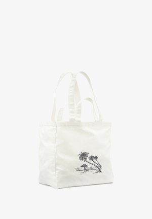White canvas tote bag with graphic of palm trees and a beach scene. Features two sturdy handles and a structured shape.