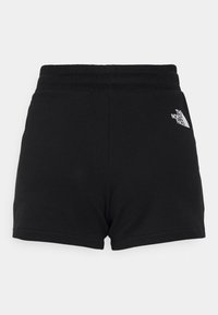 Shorts noirs à taille élastique avec le logo The North Face en blanc sur la partie supérieure de la cuisse gauche, présentés sur un fond gris clair uni.
